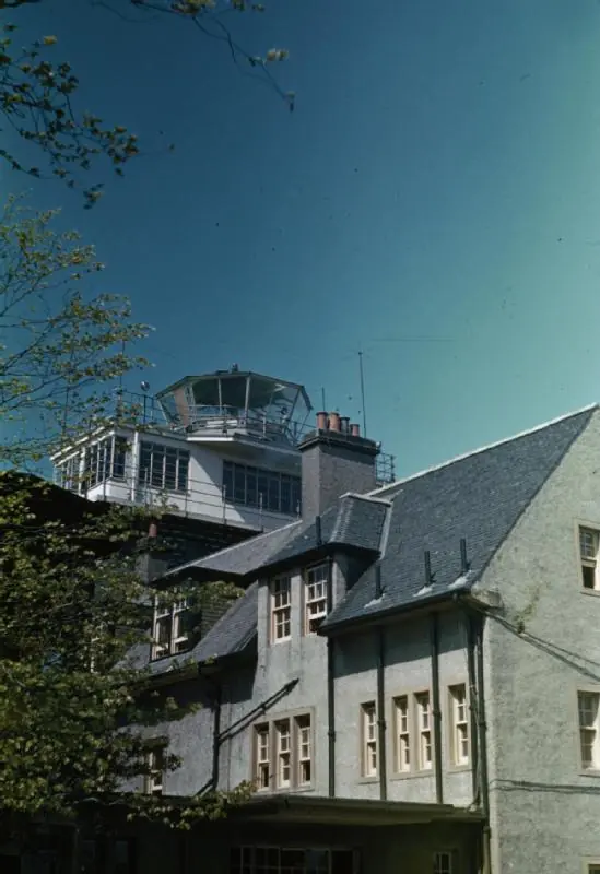 The wartime control tower rising through the roof of a large house at Prestwick, 1944